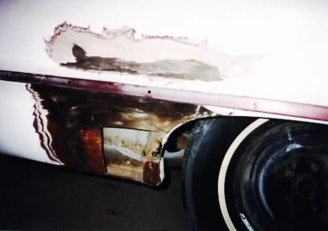 Photo showing rust cut out of quarter panel