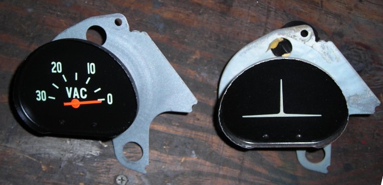 Photo of the new vacuum gauge beside the old block off plate